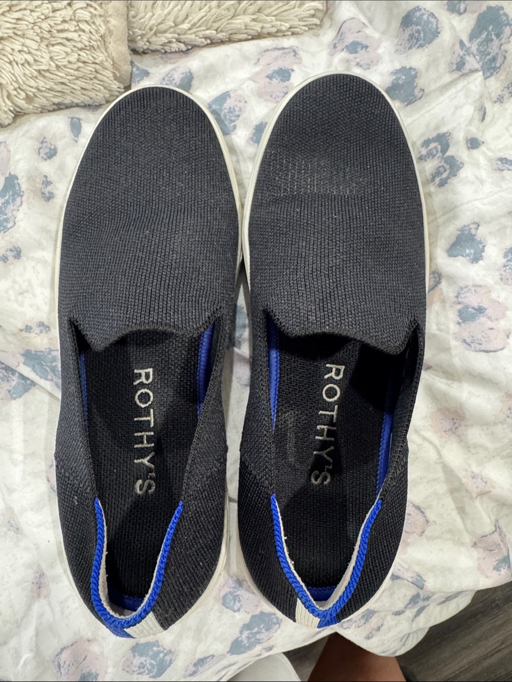 Rothy's Black Slip-On Flats with Blue Trim